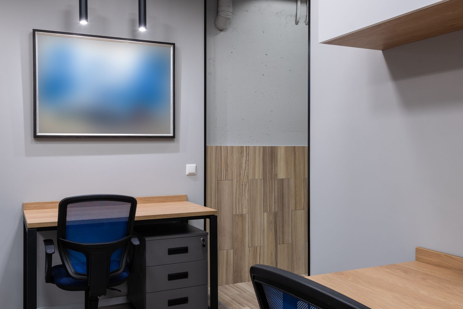Office meeting area with a whiteboard and empty chairs around a table
