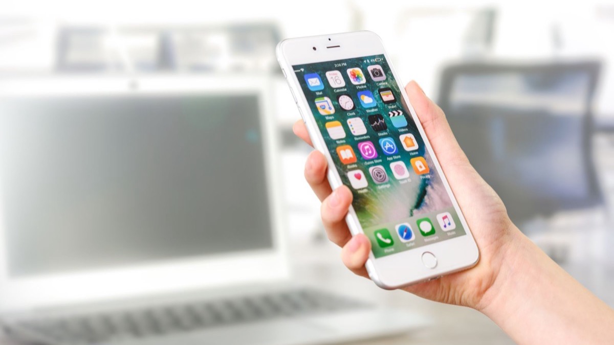 App Store and Google Play submission and review stage of a mobile app launch shown on a smartphone